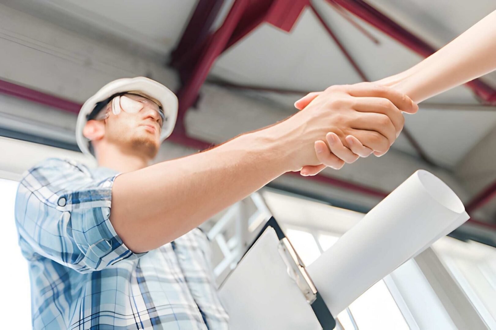 Engineer shaking hands at construction site