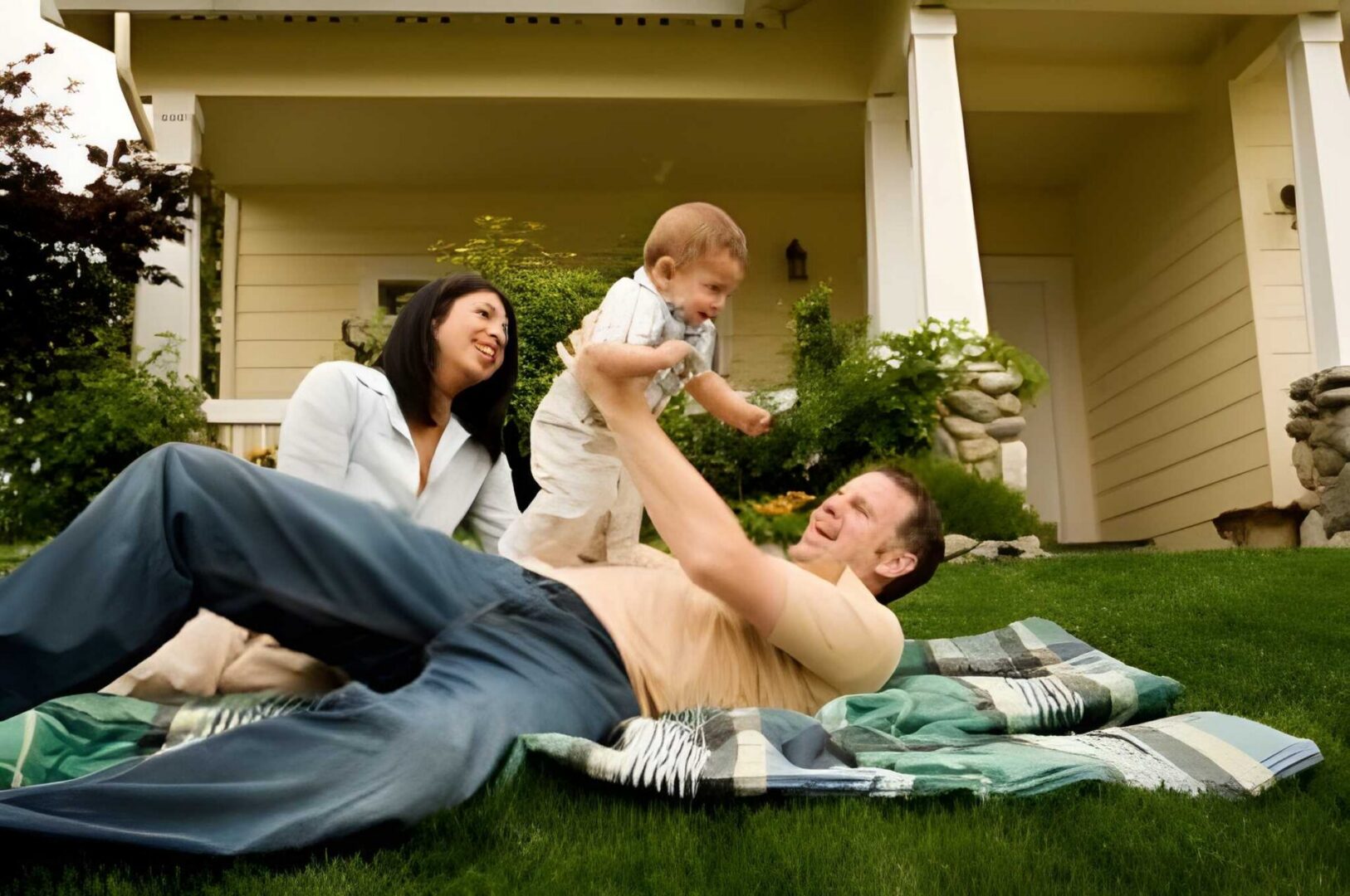 Parents and child relaxing on grass